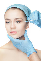 Image showing Attractive woman at plastic surgery with syringe in her face