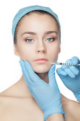 Image showing Attractive woman at plastic surgery with syringe in her face