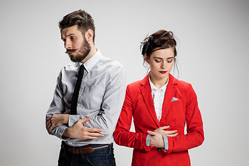 Image showing The sad business man and woman conflicting on a gray background