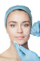 Image showing Attractive woman at plastic surgery with syringe in her face