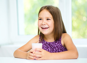 Image showing Cute little girl with a glass of milk