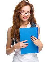 Image showing Young student girl is holding book