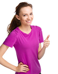 Image showing Woman is showing thumb up gesture