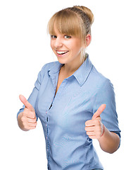 Image showing Woman is showing thumb up gesture