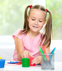 Image showing Girl is having fun while playing with plasticine