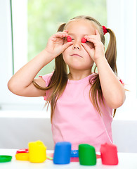 Image showing Girl is having fun while playing with plasticine