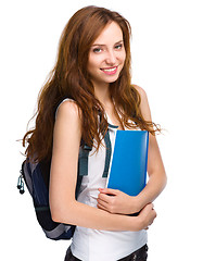 Image showing Young student girl is holding book