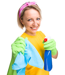 Image showing Young woman with cleaning liquid and rag