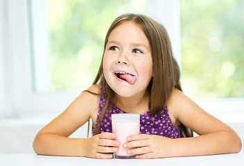 Image showing Cute little girl with a glass of milk