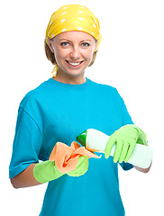 Image showing Young woman with cleaning liquid and rag
