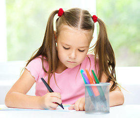 Image showing Cute cheerful child drawing using felt-tip pen