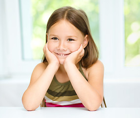 Image showing Little girl is holding her face