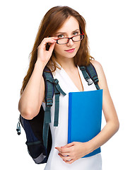 Image showing Young student girl is holding book