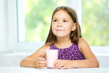 Image showing Cute little girl with a glass of milk