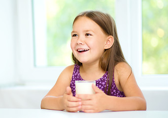 Image showing Cute little girl with a glass of milk