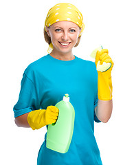 Image showing Young woman with cleaning liquid and sponge