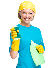 Image showing Young woman with cleaning liquid and sponge