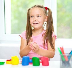 Image showing Little girl is playing with plasticine