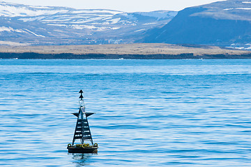 Image showing Buoy silhouette in the blue ocean