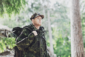 Image showing young soldier with backpack in forest