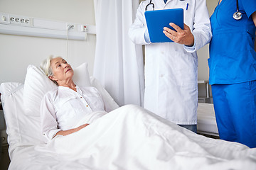 Image showing doctor and nurse visiting senior woman at hospital