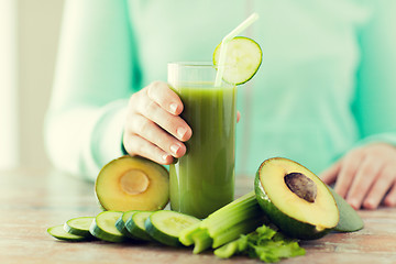 Image showing close up of woman hands with juice and vegetables