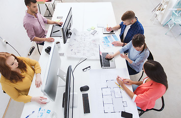 Image showing creative team with computers, blueprint at office