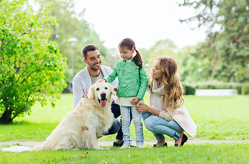 Image showing happy family with labrador retriever dog in park