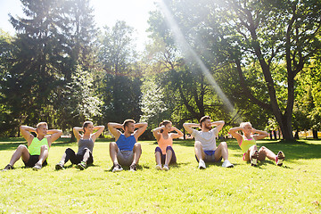 Image showing group of friends or sportsmen exercising outdoors