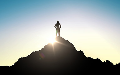 Image showing silhouette of businessman on mountain top