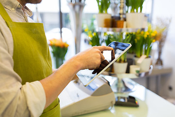 Image showing close up of man with tablet pc at flower shop