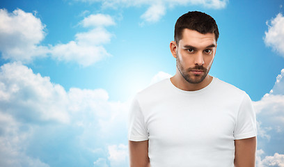 Image showing young man portrait over sky and clouds background