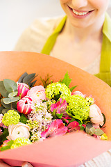 Image showing close up of woman with bunch at flower shop