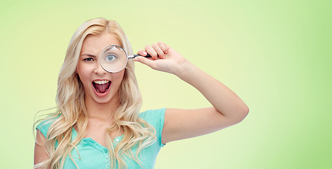 Image showing happy young woman with magnifying glass