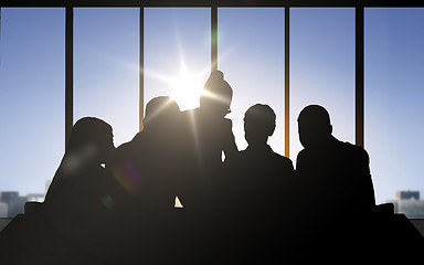 Image showing business people silhouettes over office background