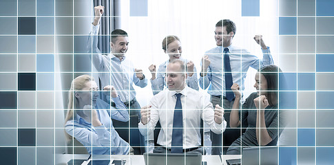 Image showing business people celebrating victory in office