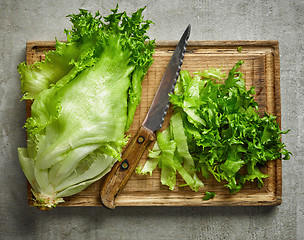 Image showing fresh green lettuce on wooden cutting board