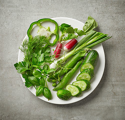 Image showing plate of various fresh raw herbs and vegetables