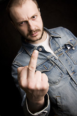 Image showing young man giving the middle finger