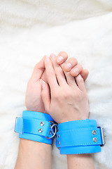 Image showing Male and female hands in handcuffs. sexy couple in bed. sex Toys