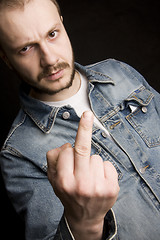 Image showing young man giving the middle finger