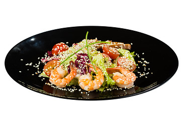 Image showing perfect dish with shrimps on a black plate. seafood. Isolated  white background