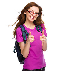 Image showing Young student girl is showing thumb up sign
