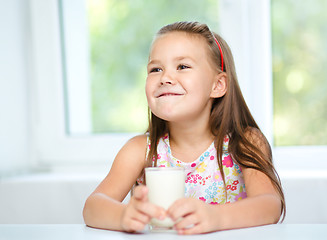 Image showing Cute little girl with a glass of milk