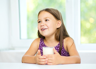 Image showing Cute little girl with a glass of milk