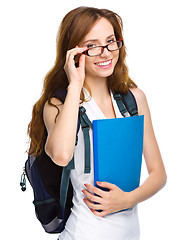 Image showing Young student girl is holding book