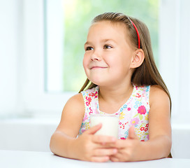 Image showing Cute little girl with a glass of milk