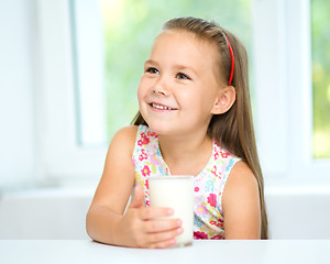 Image showing Cute little girl with a glass of milk