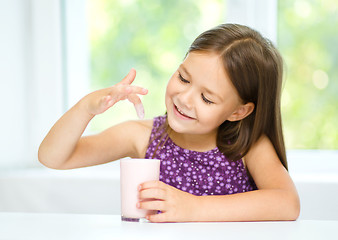 Image showing Little girl with a glass of milk