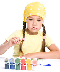 Image showing Cute thoughtful child play with paints